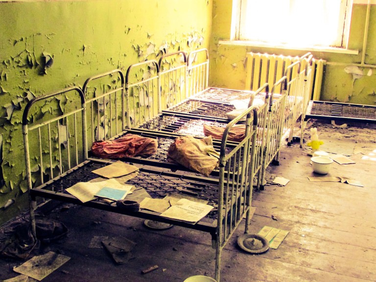 På rekke og rad står sengene inne på det som var en av sovesalene.